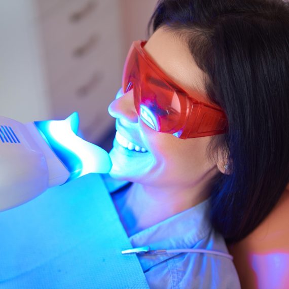 A woman sitting in a dentist's chair.