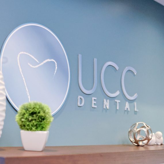 The UCC Dental logo in the office. Learn more about us.