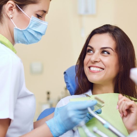 A woman sitting in a dentist's chair.